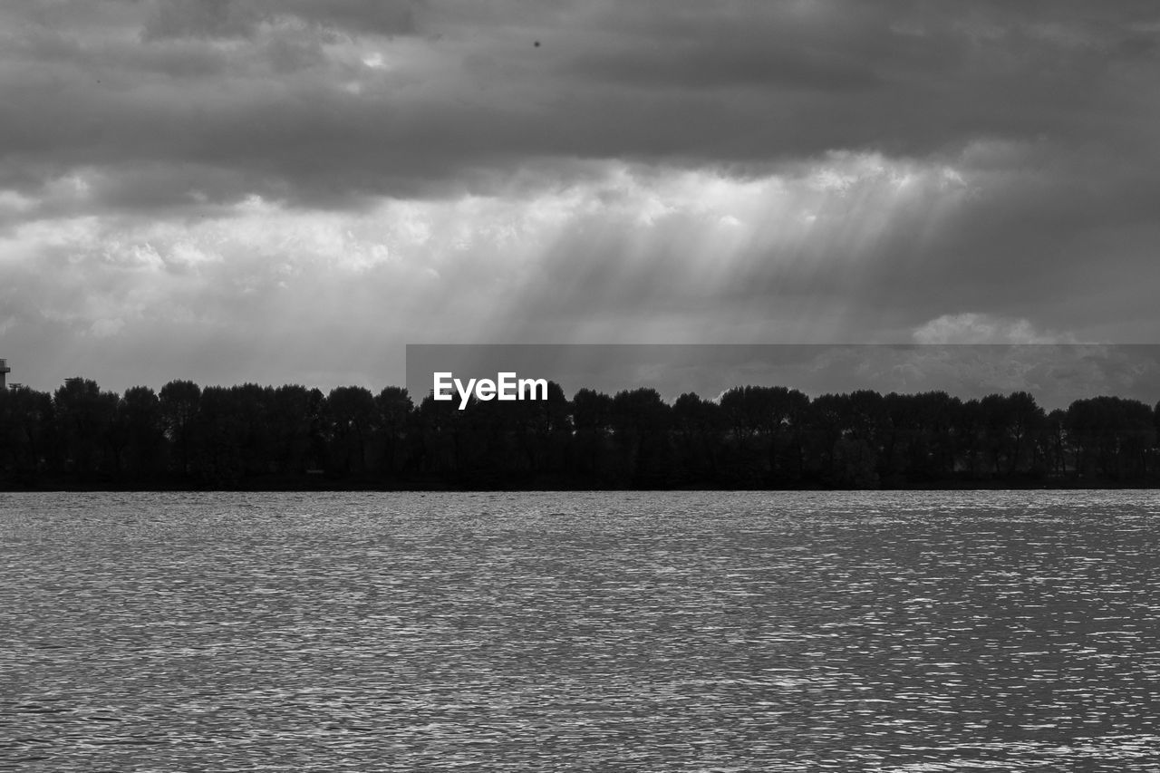 Scenic view of sea against storm clouds