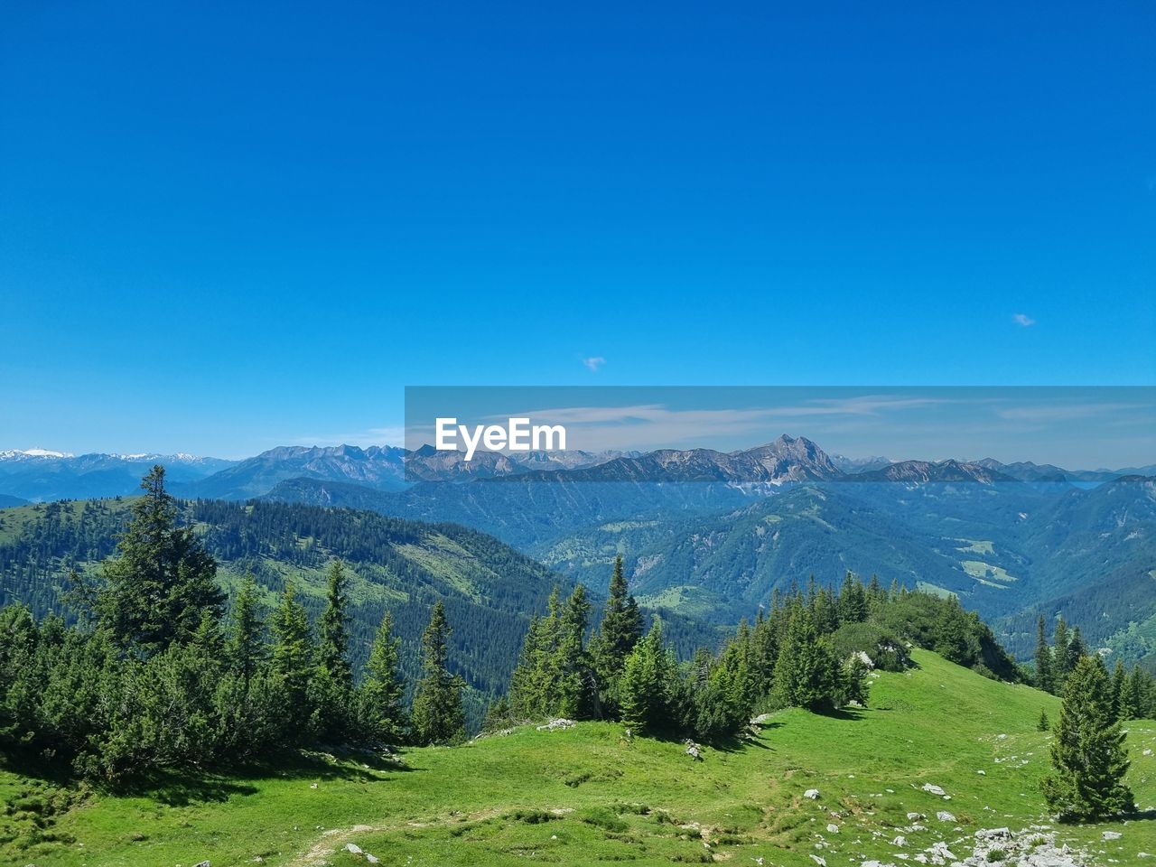 Scenic view of mountains against clear blue sky