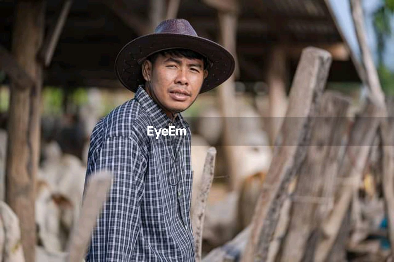 Portrait of man wearing hat standing outdoors