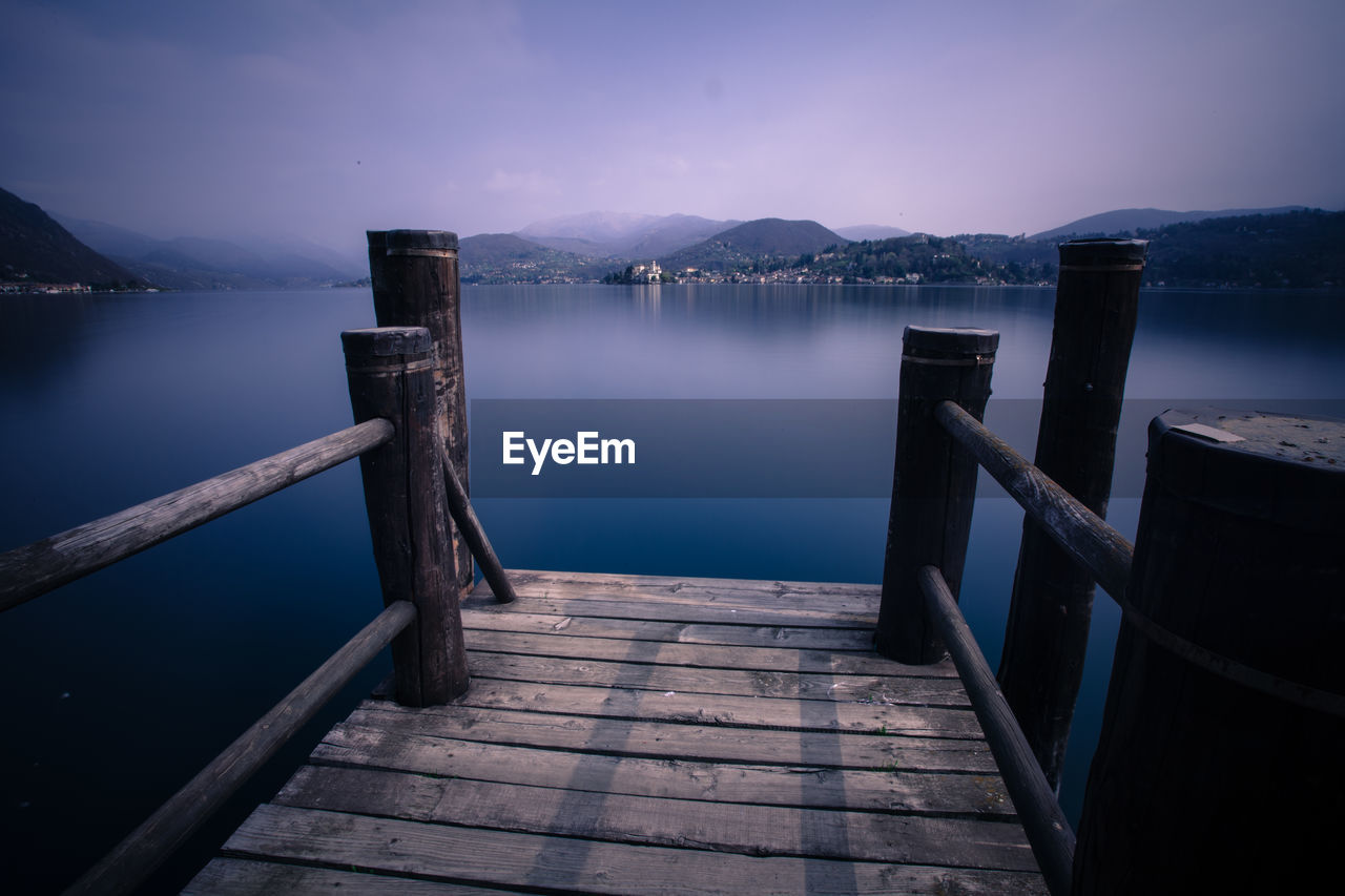 Scenic view of lake against cloudy sky