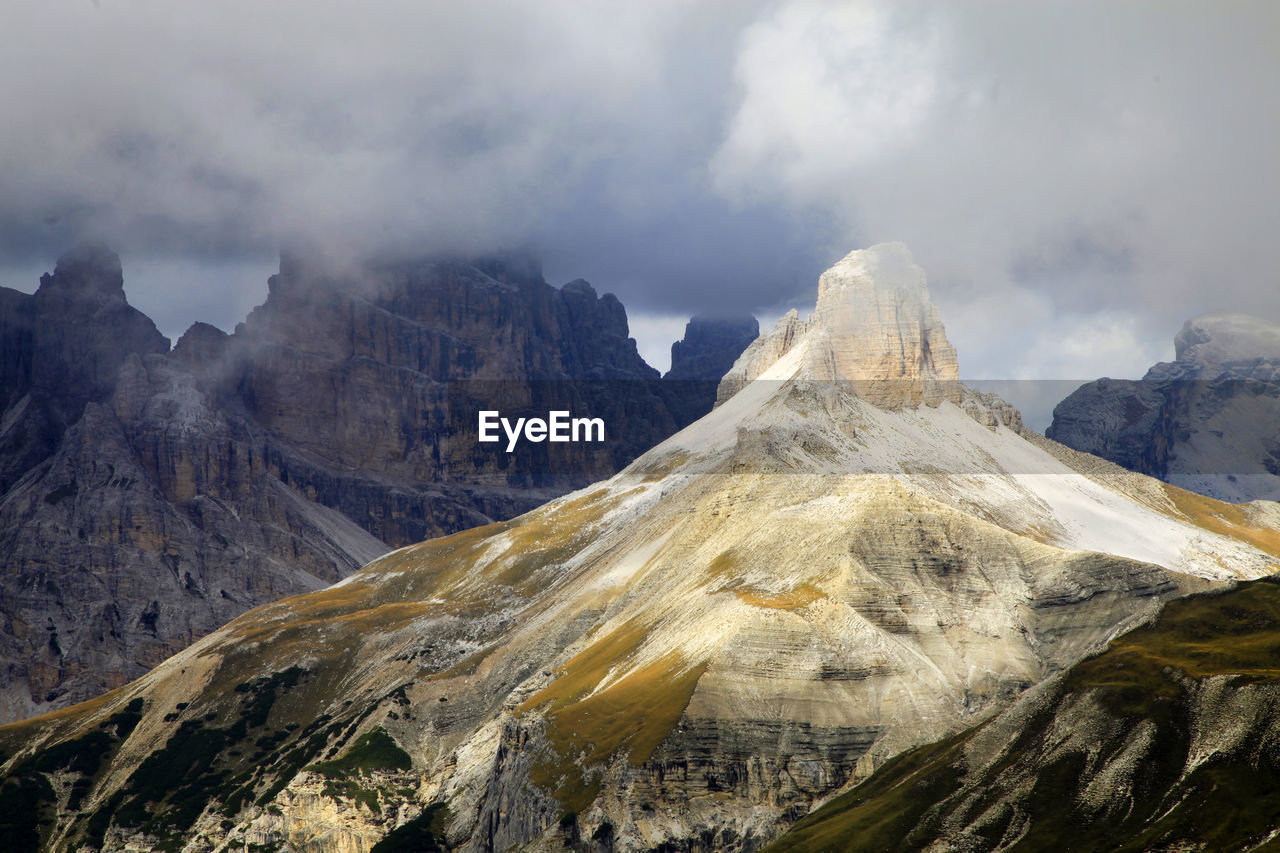 Idyllic view of dolomites against cloudy sky
