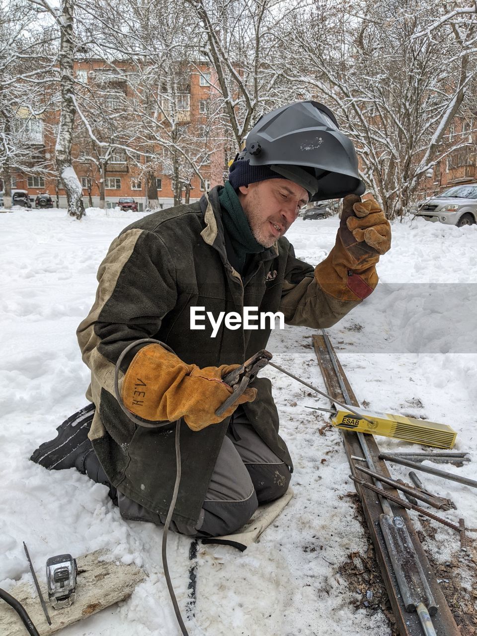 rear view of man working on snow