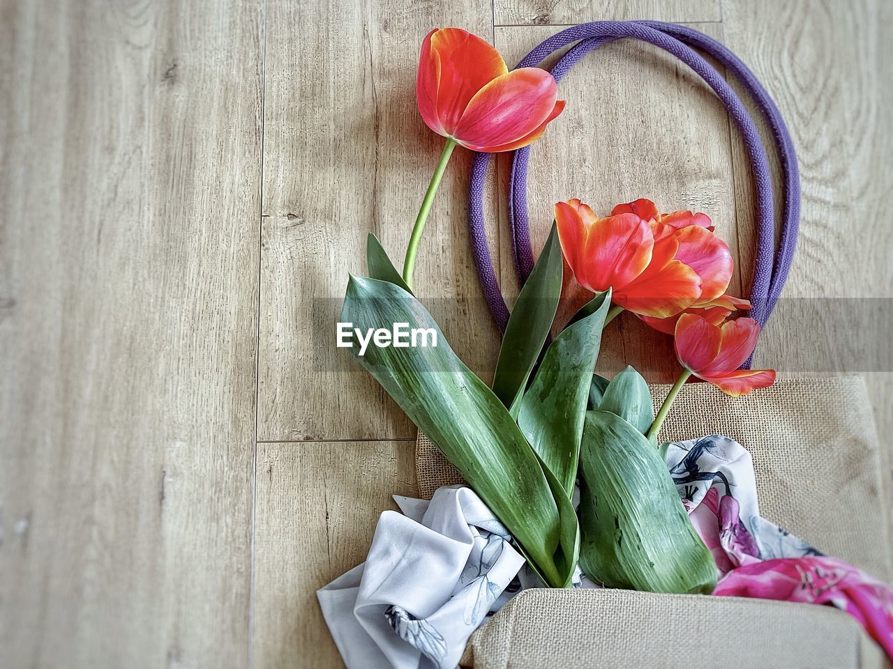 plant, flower, flowering plant, freshness, indoors, nature, still life, no people, beauty in nature, pink, wood, tulip, high angle view, table, bouquet, close-up, plant part, leaf, flower head, petal, art, directly above, arrangement, decoration, inflorescence, flower arrangement, fragility, green