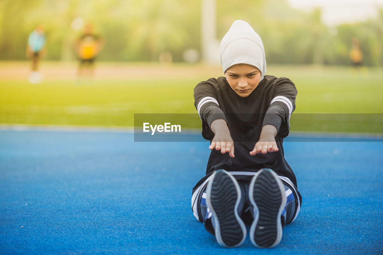 Female athlete exercising on running track