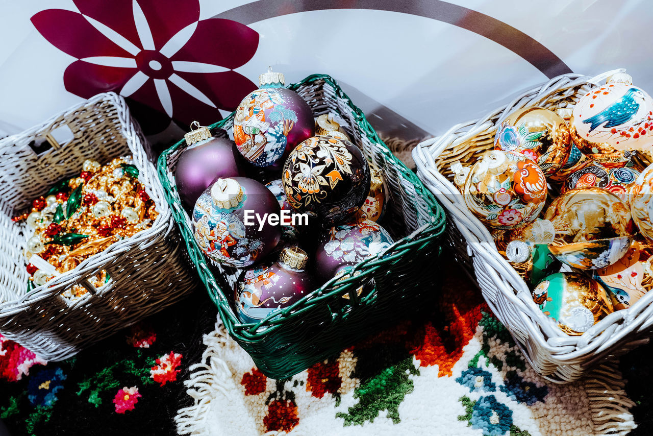 Wicker baskets with christmas toys balls with winter design. christmas tree and new year atmosphere