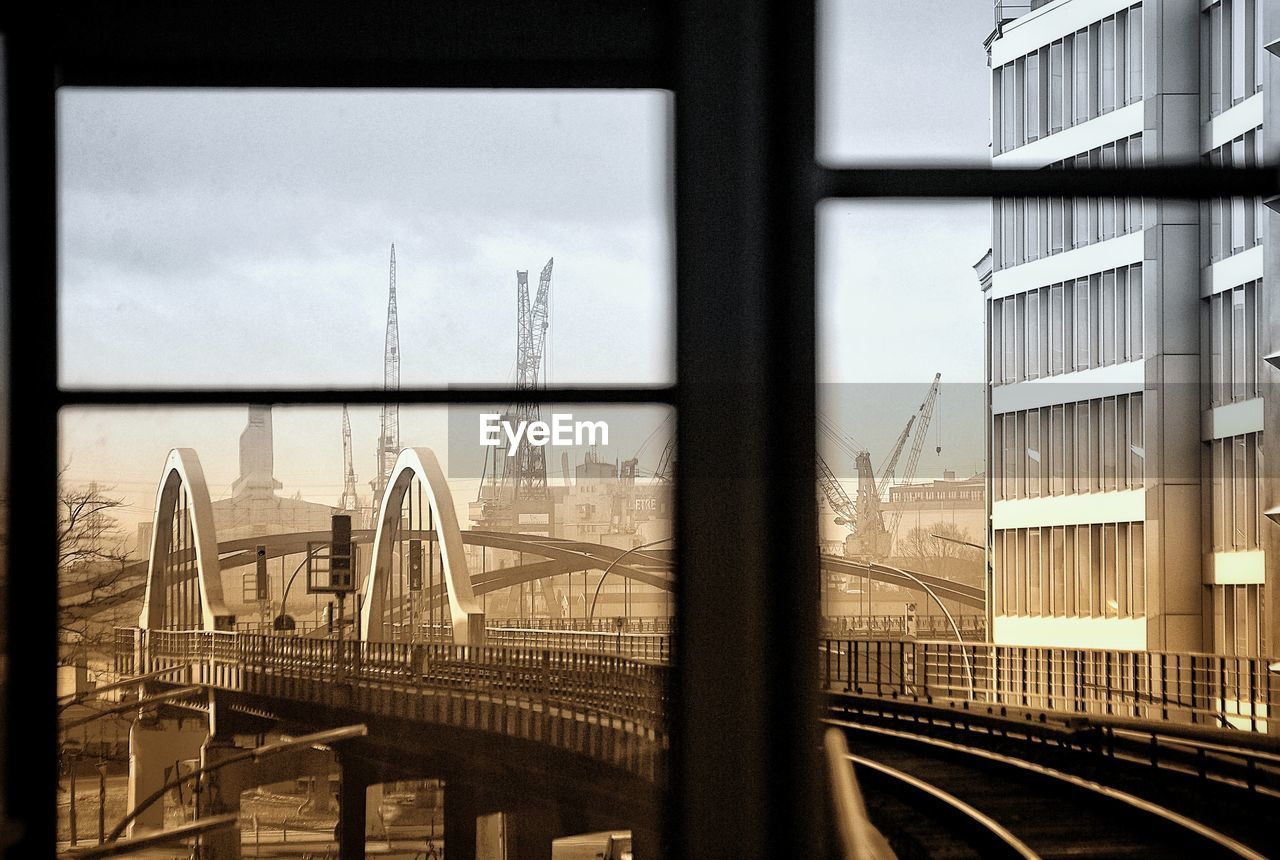 Panoramic view of railroad tracks and bridge against sky