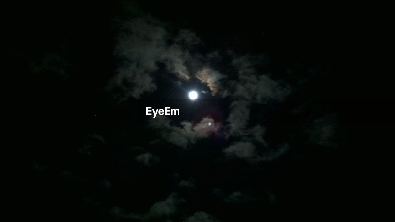 LOW ANGLE VIEW OF MOON IN SKY AT NIGHT