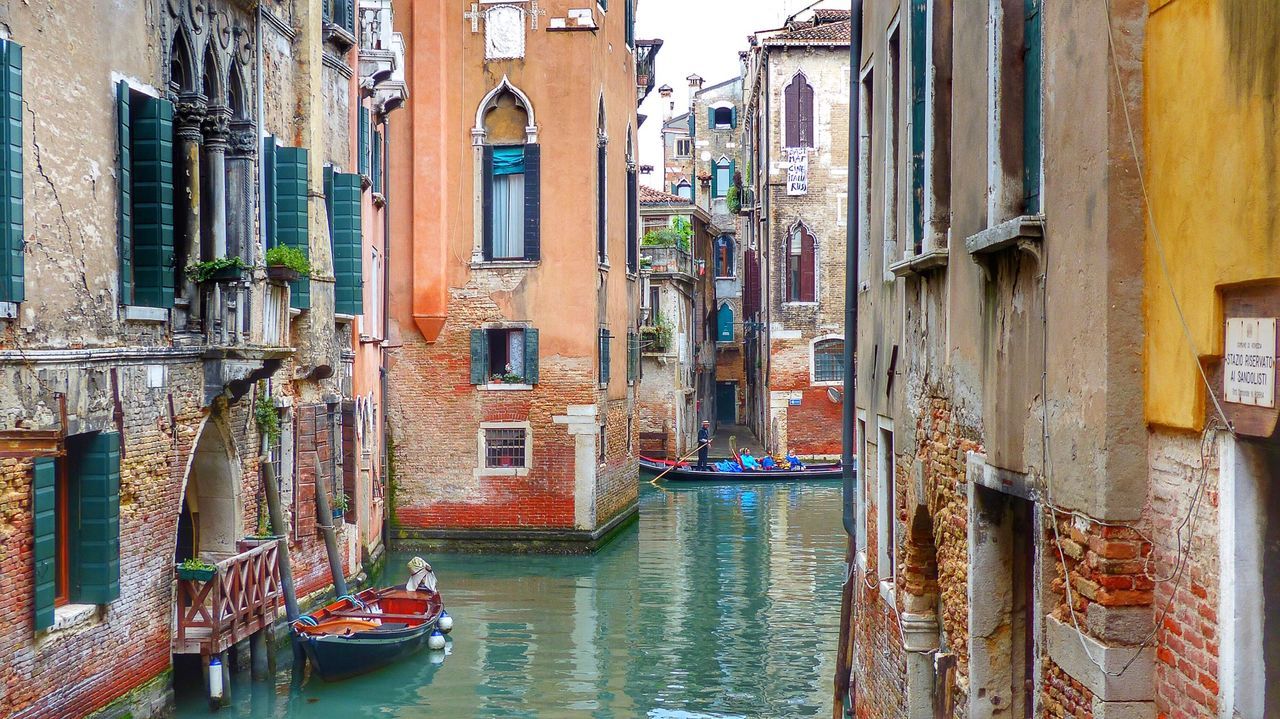 Canal amidst old buildings