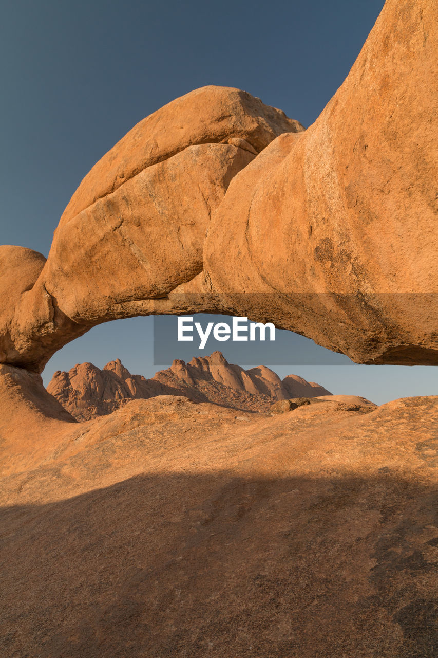 SCENIC VIEW OF ROCK FORMATIONS IN DESERT AGAINST SKY