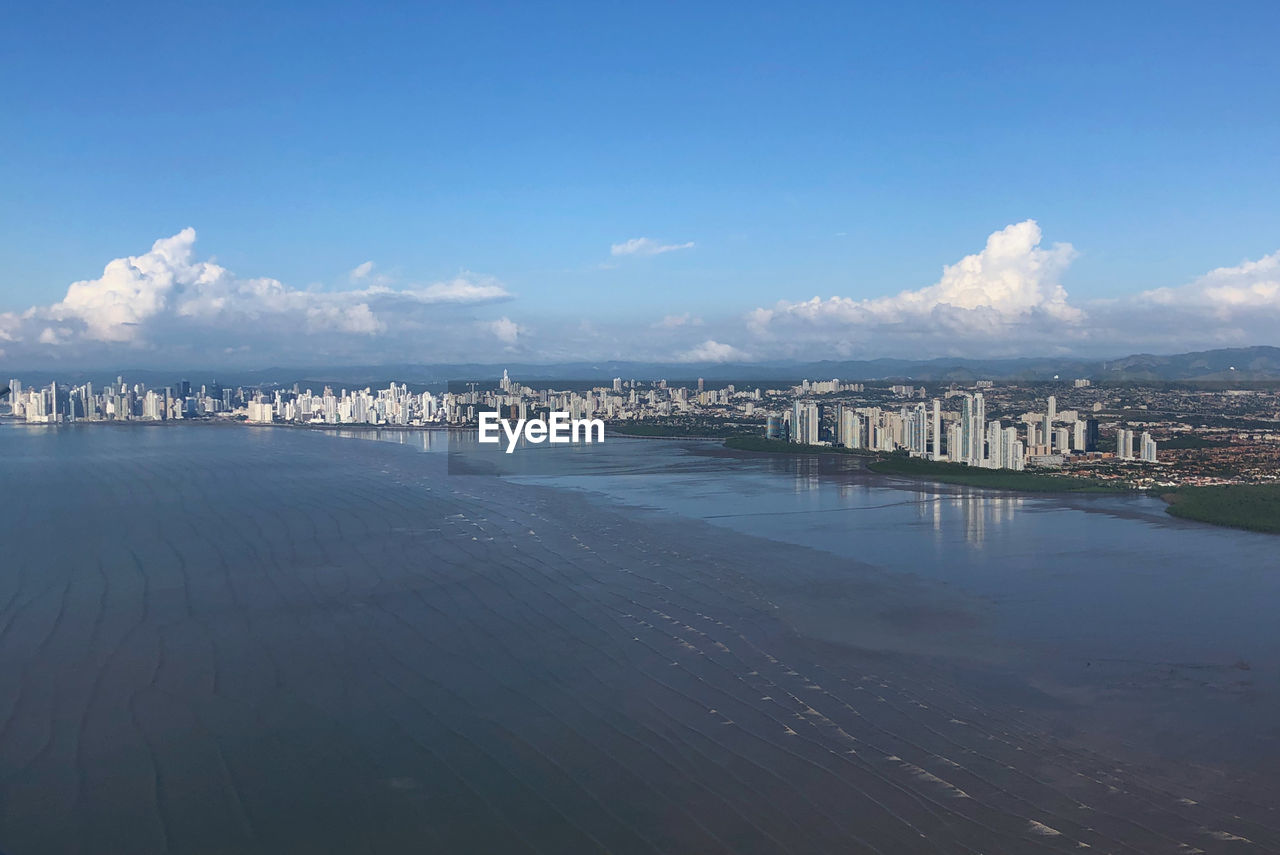 Panoramic view of sea and buildings against sky