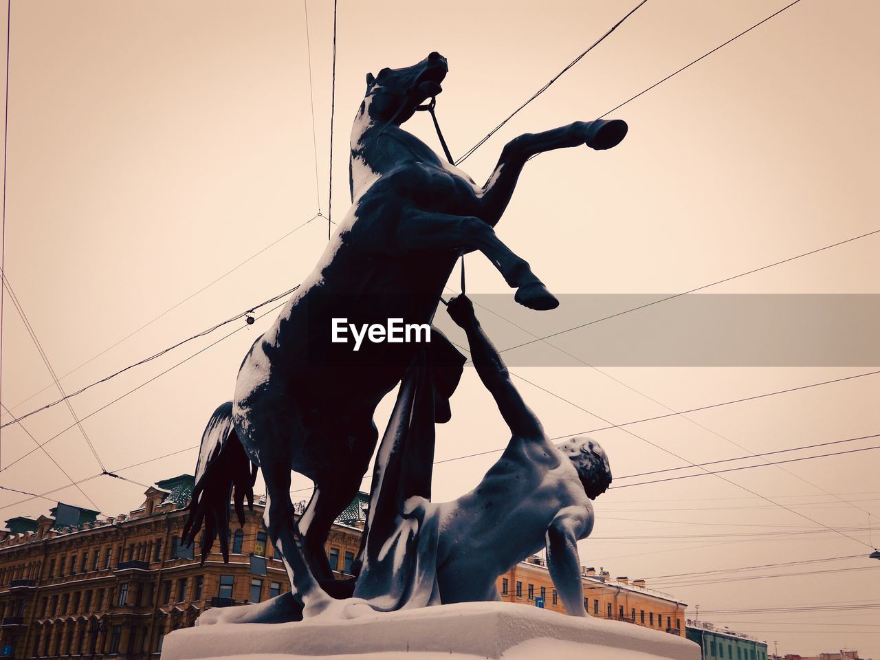 statue, sky, architecture, cable, nature, low angle view, person, electricity, horse, sunset, domestic animals, sculpture, animal, art, power line, mammal, craft, outdoors, built structure