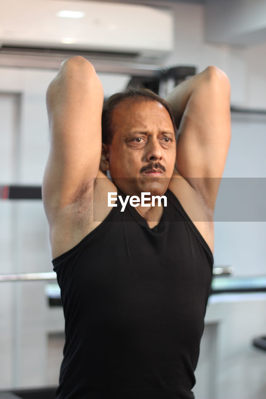 Determined man exercising in gym