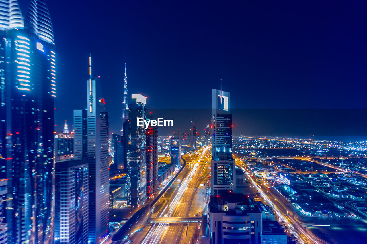 High angle view of illuminated buildings in city at night in dubai 