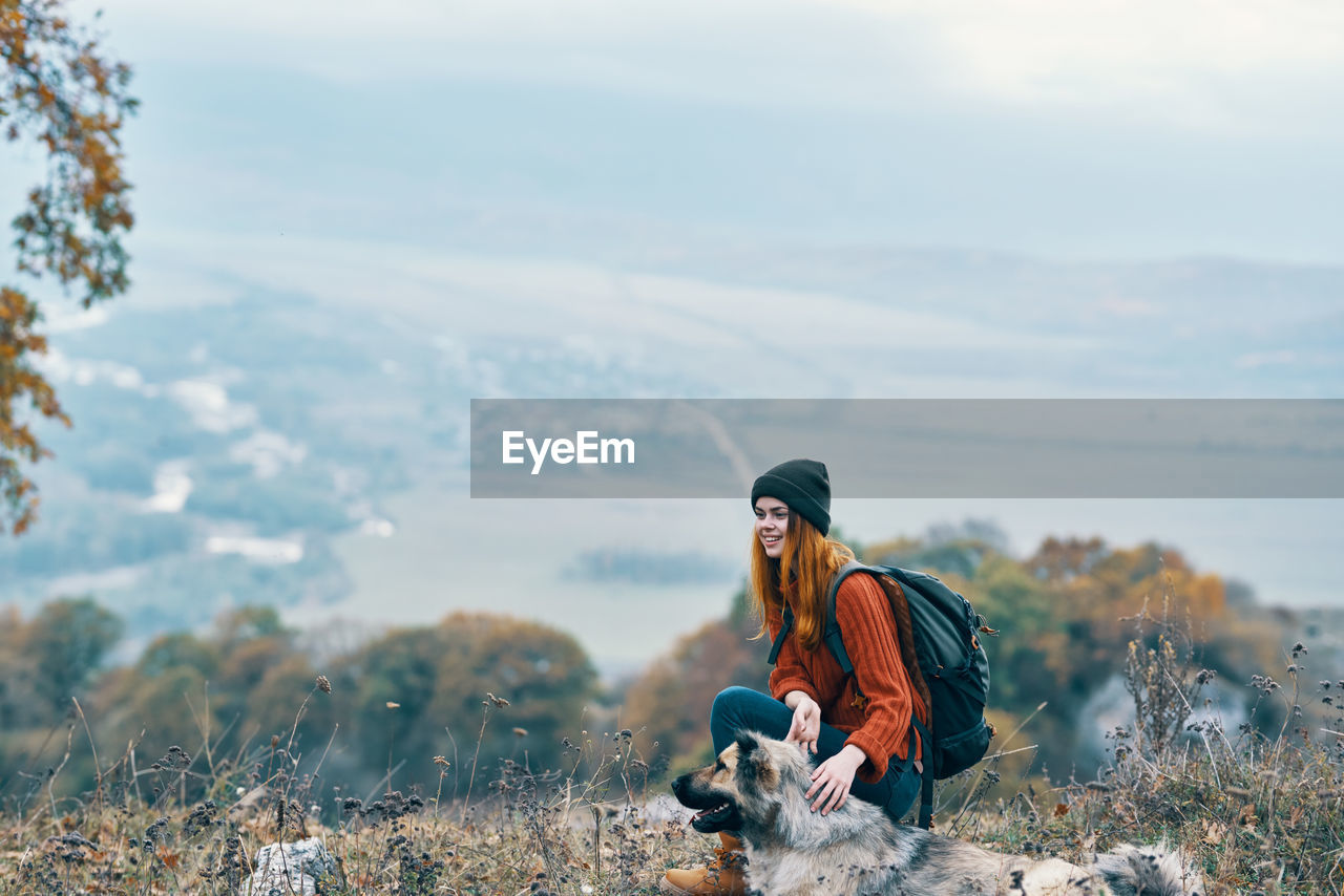 YOUNG WOMAN LOOKING AWAY ON MOUNTAIN