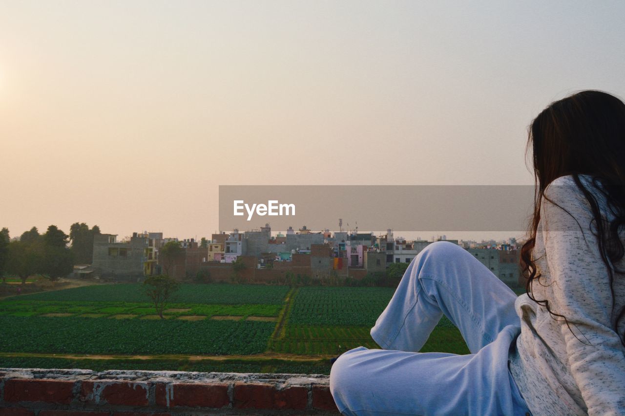 Rear view of girl looking at cityscape