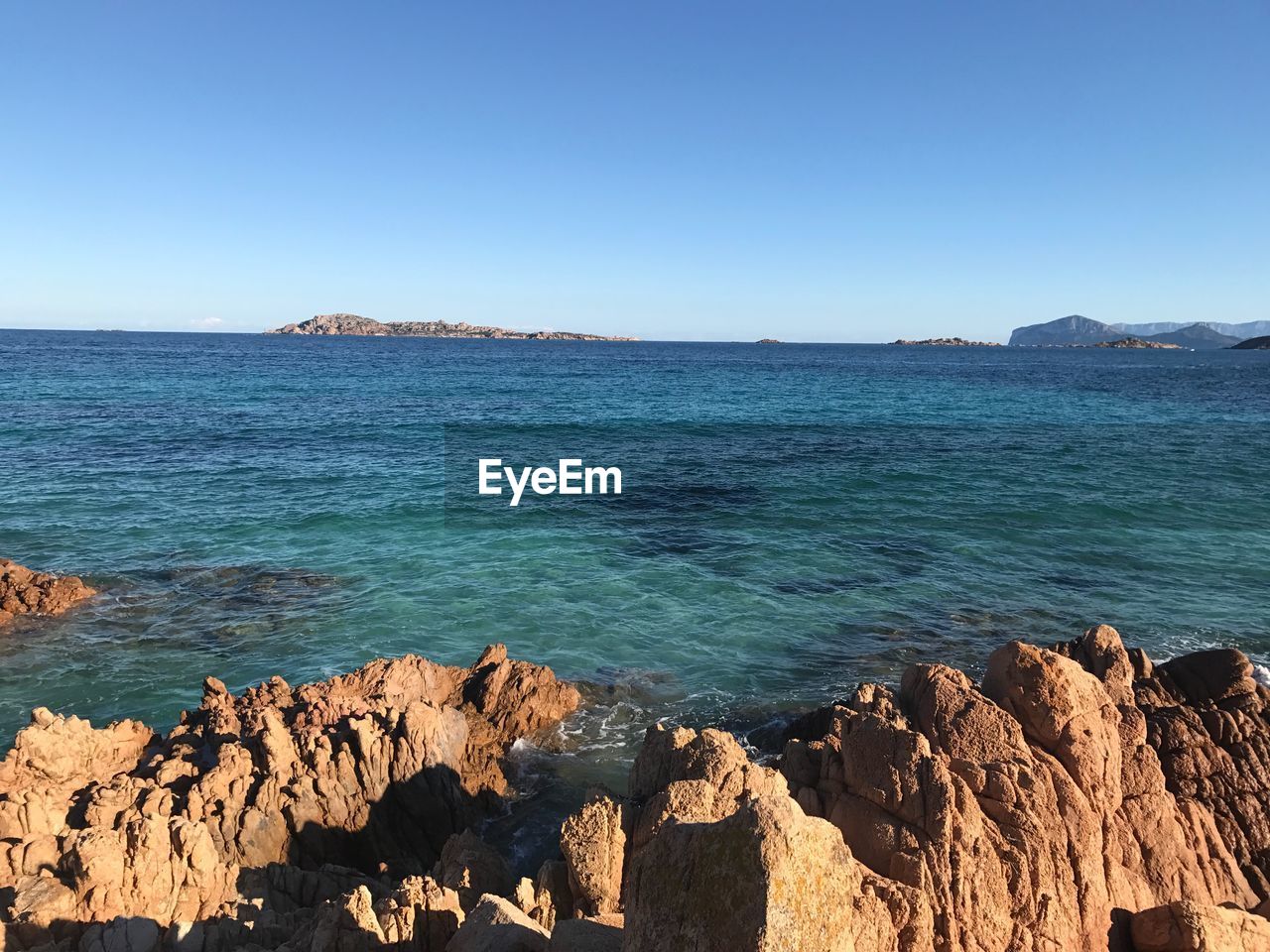 Scenic view of sea against clear blue sky