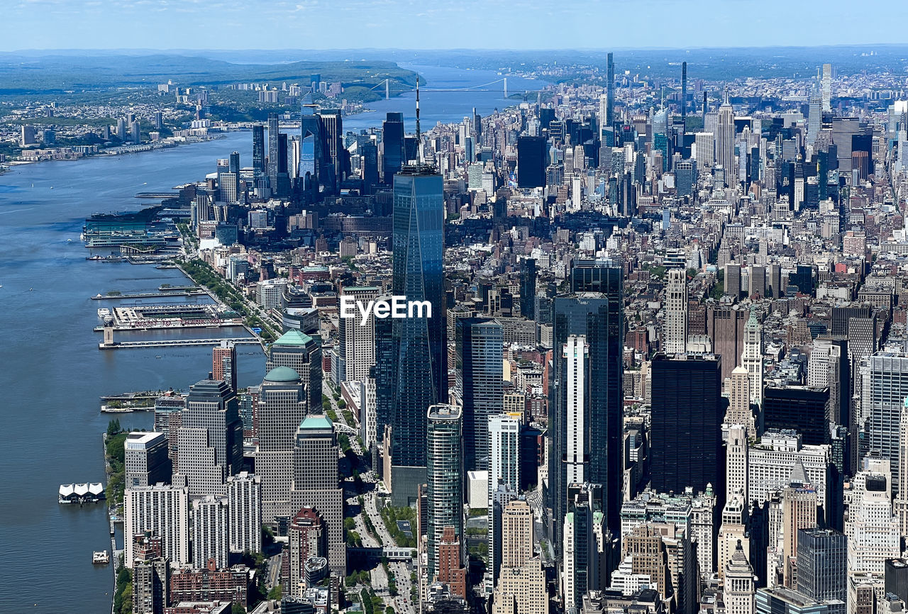 city, architecture, cityscape, built structure, building exterior, metropolis, metropolitan area, building, skyscraper, office building exterior, aerial photography, skyline, water, landscape, urban skyline, aerial view, sky, travel destinations, urban area, residential district, nature, tower block, horizon, high angle view, downtown district, no people, downtown, sea, bird's-eye view, travel, transportation, office, landmark, tower, city life, outdoors, business, tourism, day, nautical vessel, financial district, residential area, business finance and industry, bay of water, bay