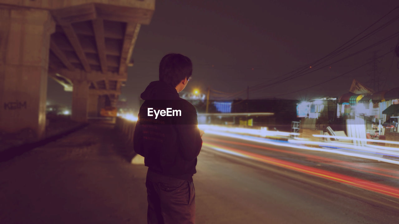 Man on street at night