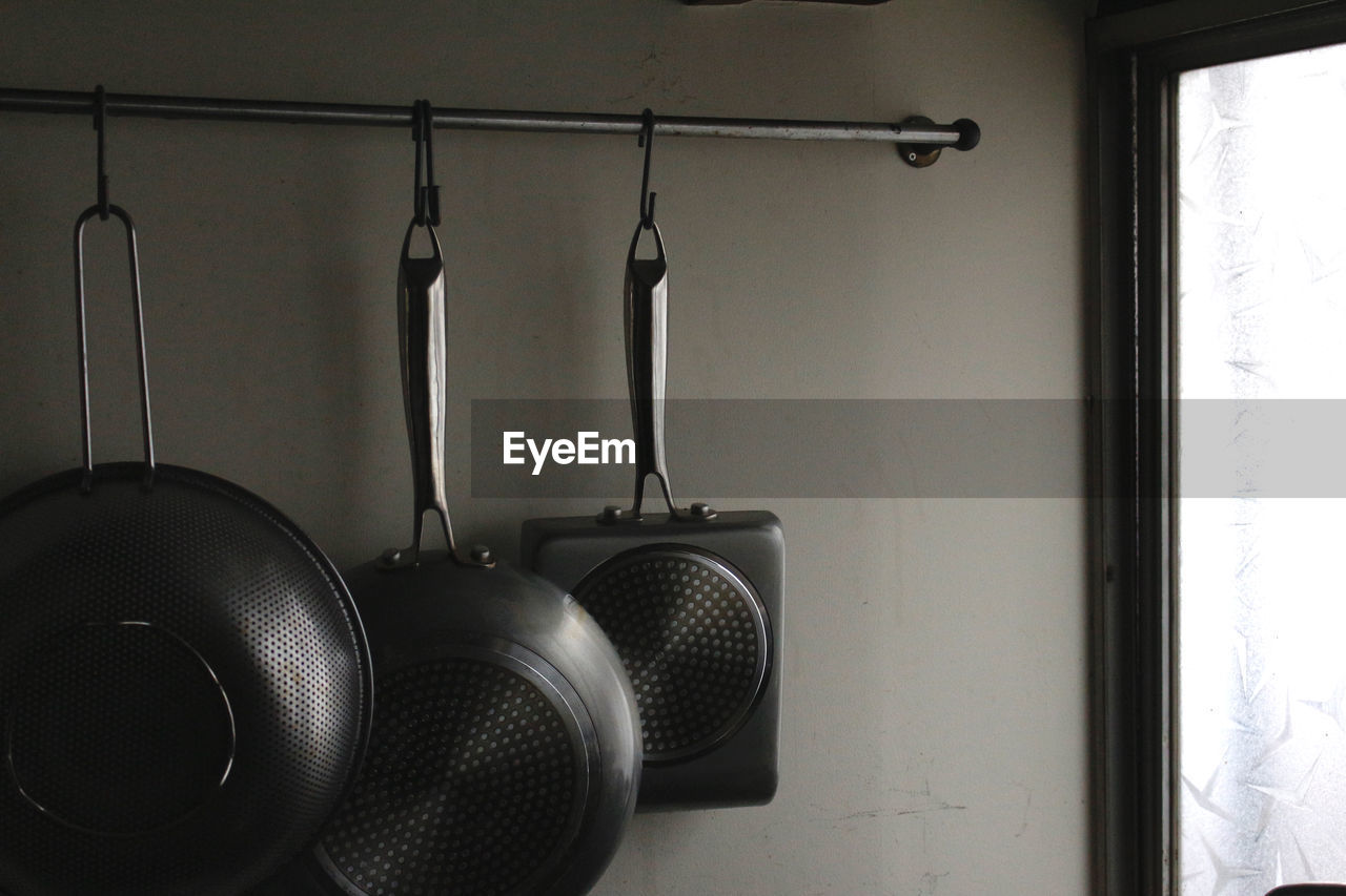 Close-up of kitchen utensils hanging at home