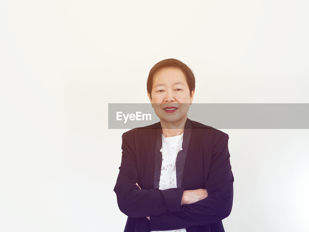 PORTRAIT OF SMILING MAN AGAINST WHITE BACKGROUND