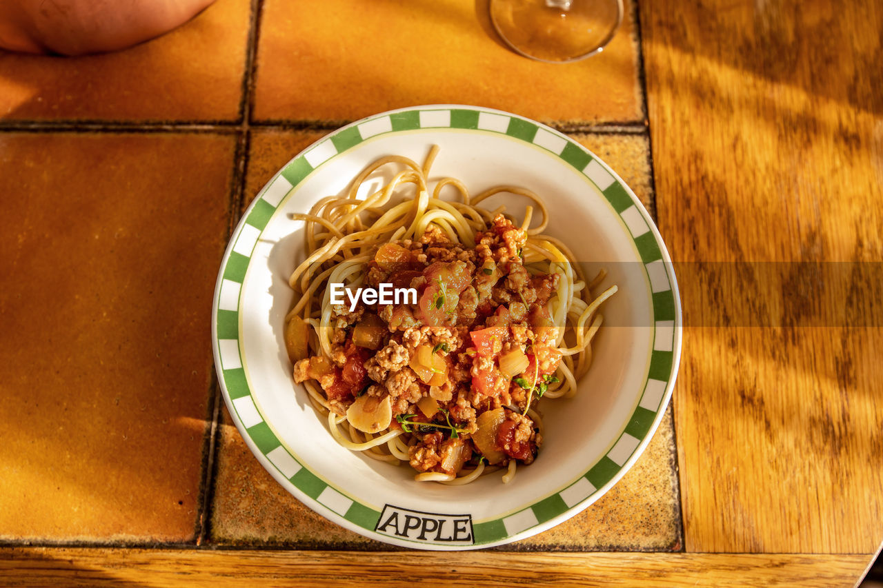 HIGH ANGLE VIEW OF PASTA SERVED ON TABLE