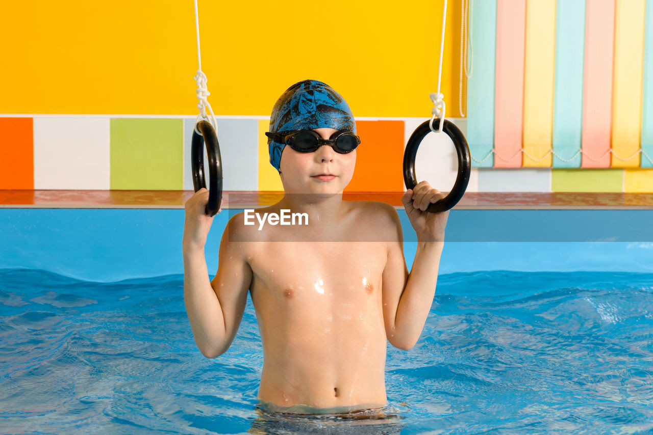 Shirtless boy in swimming pool