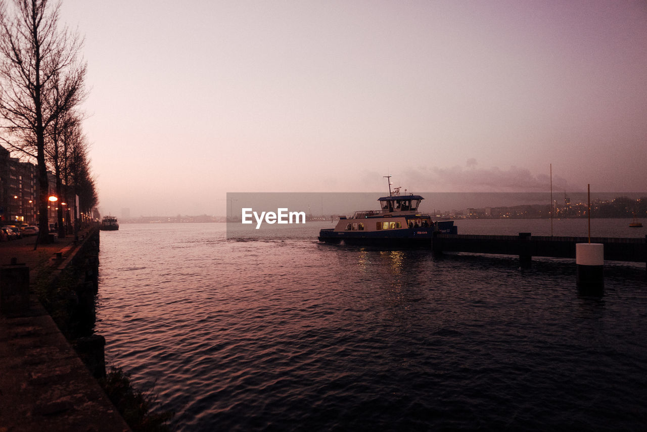 SHIP IN SEA AGAINST CLEAR SKY AT SUNSET