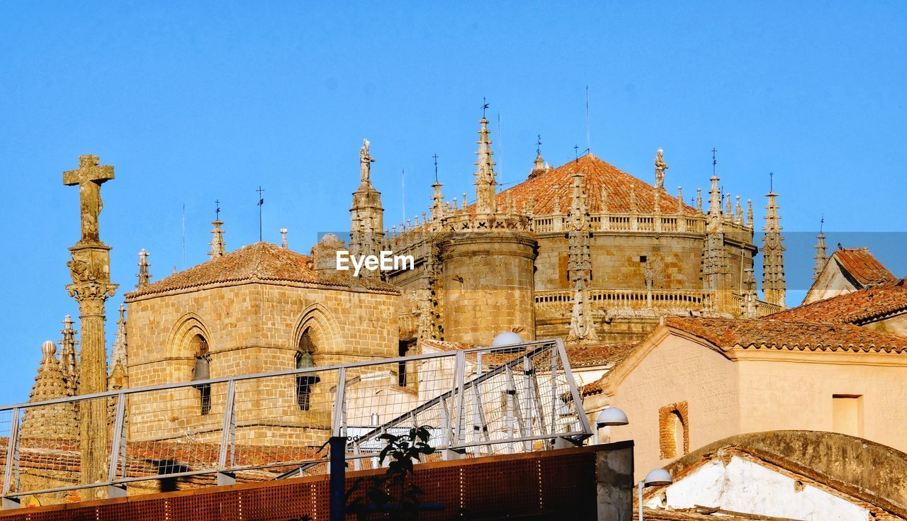 Low angle view of historic building against clear blue sky medieval town. plasencia 