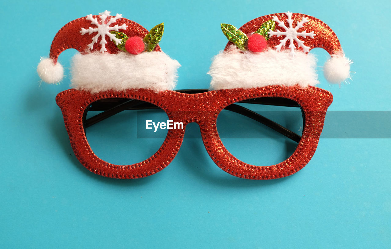 colored background, studio shot, fashion, red, indoors, no people, blue, holiday, glasses, blue background, close-up, clothing, sunglasses, still life, cut out