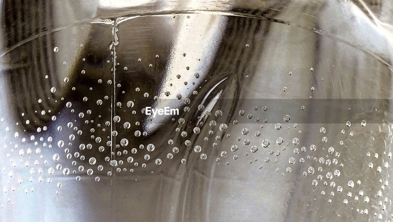 CLOSE-UP OF WATER DROPS ON METALLIC METAL