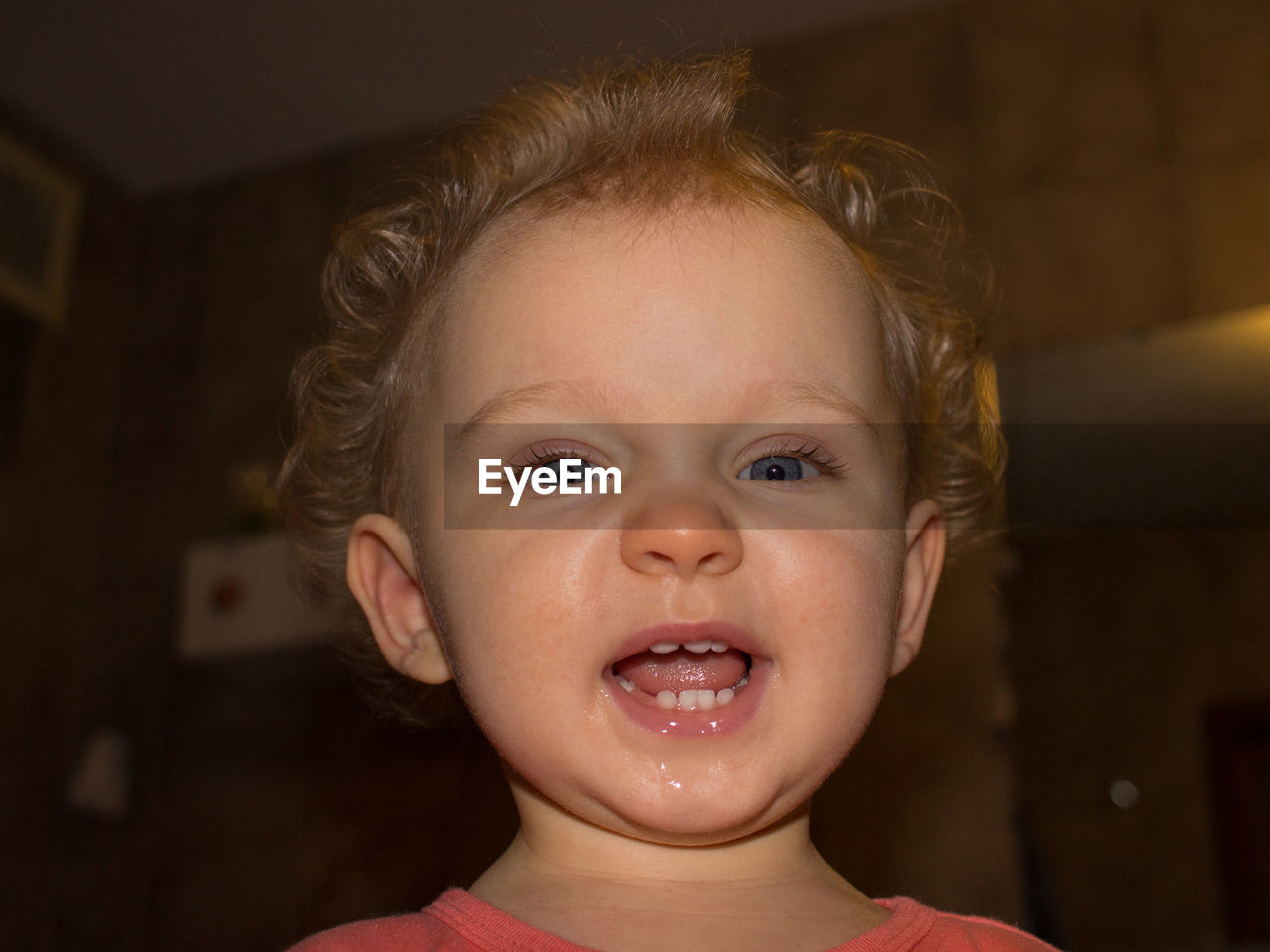 Close-up portrait of cute baby girl at home