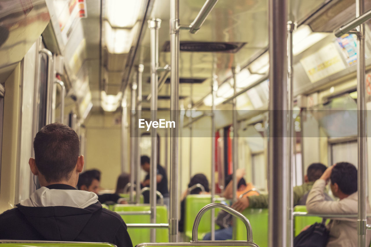 Rear view of man sitting in train