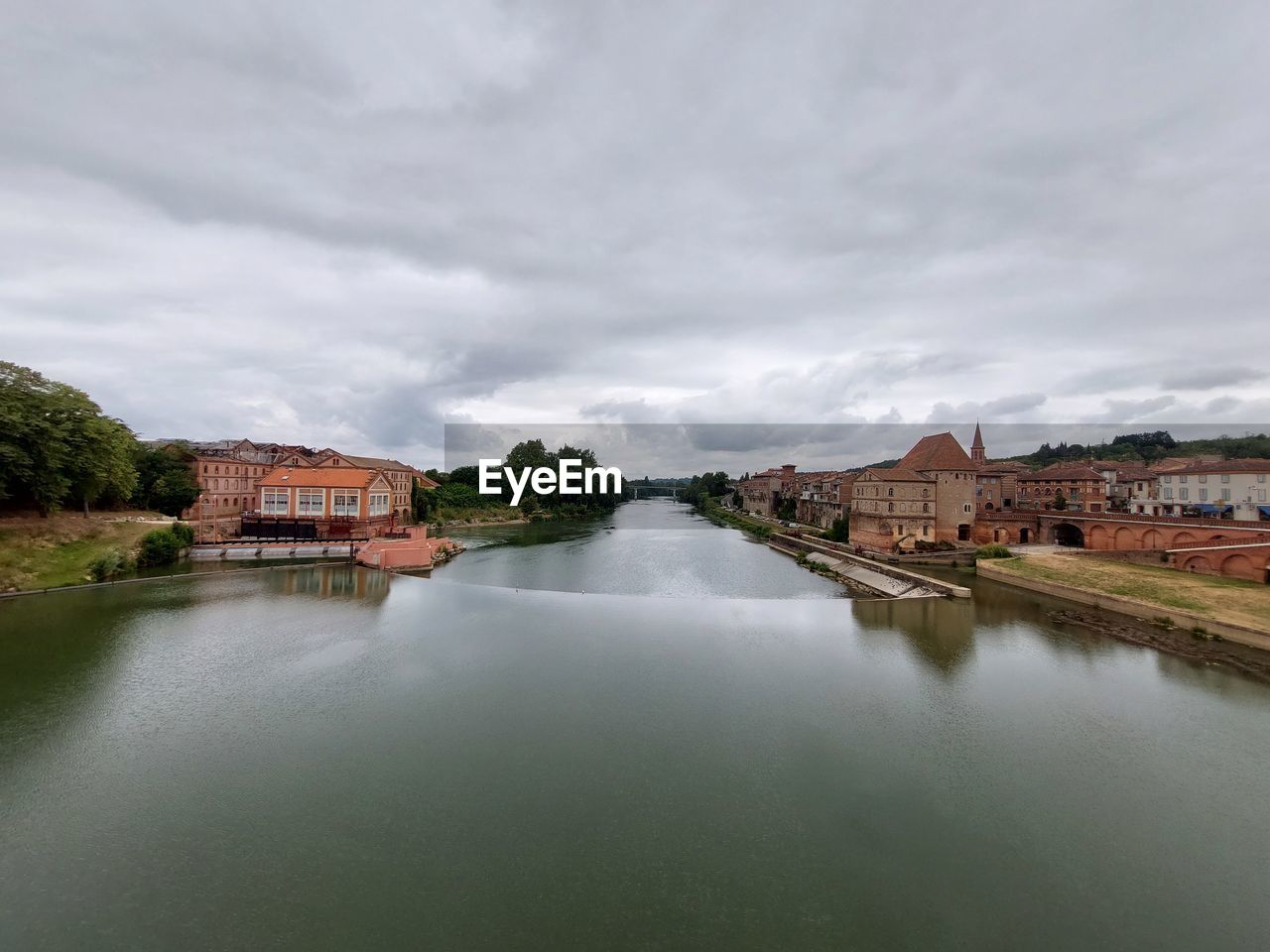 water, architecture, reflection, river, built structure, building exterior, cloud, sky, building, travel destinations, body of water, nature, environment, waterway, city, house, landscape, travel, reservoir, tourism, no people, overcast, residential district, history, the past, outdoors, scenics - nature, beauty in nature, morning, land, tranquility, cityscape, trip, day, vacation, business finance and industry, holiday, town, bridge, religion