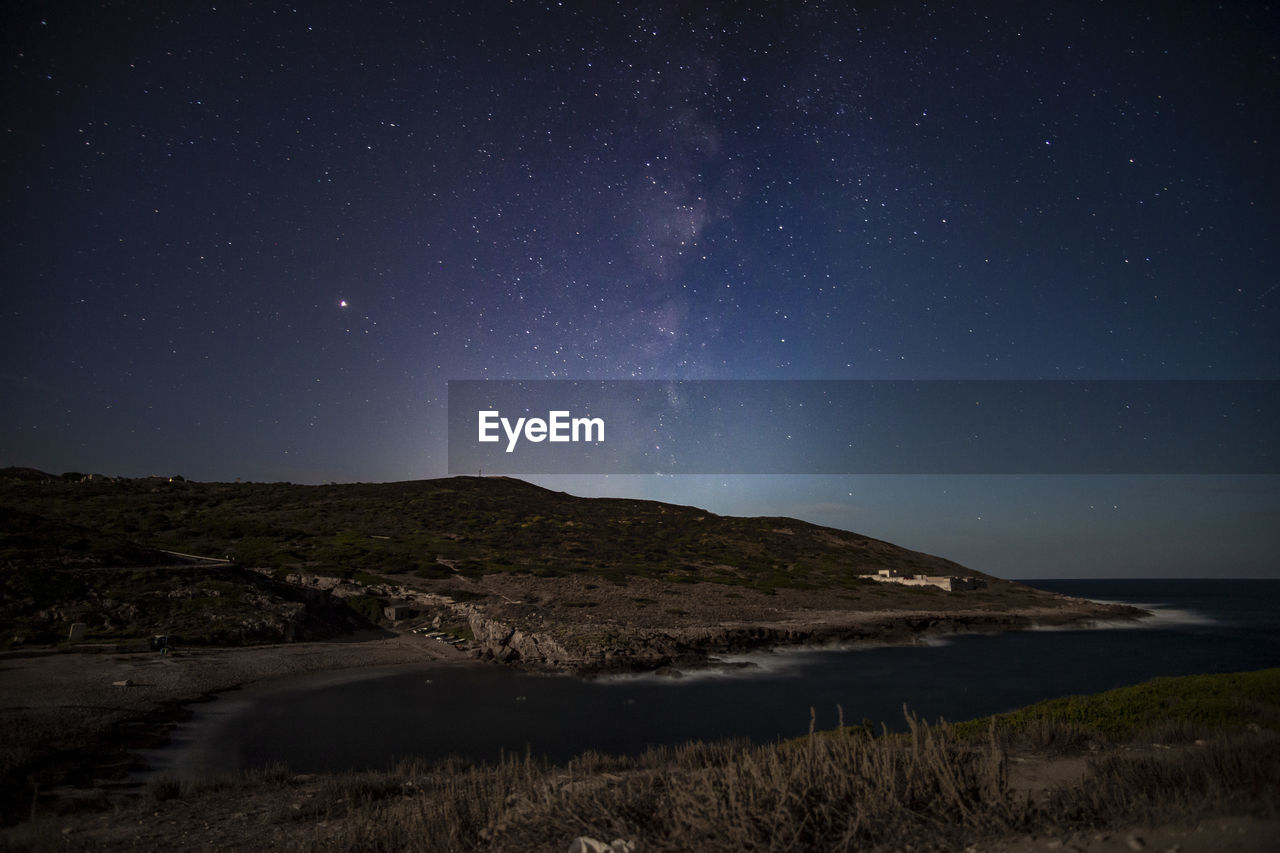 Scenic view of mountains against sky at night