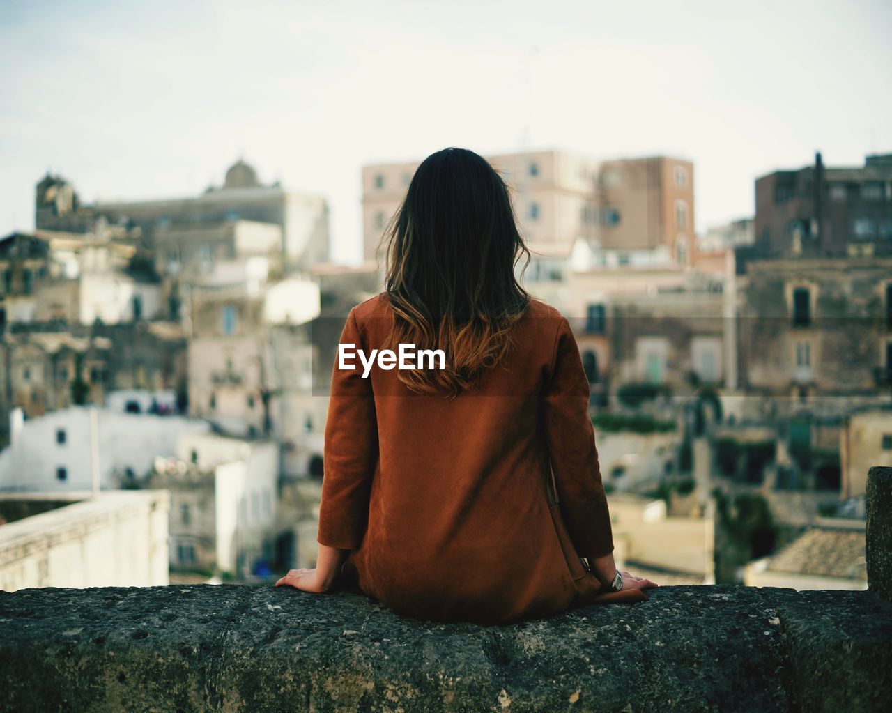 Rear view of woman looking at cityscape