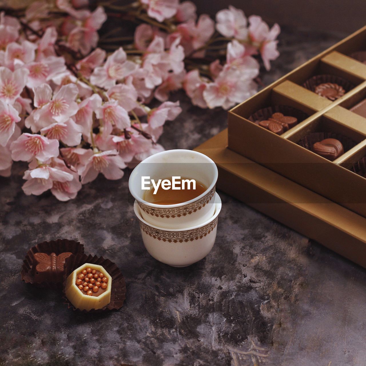 High angle view of tea and chocolates on table