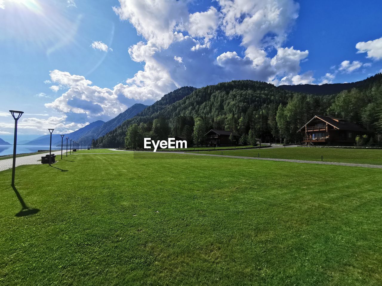 SCENIC VIEW OF GRASSY LANDSCAPE AGAINST SKY