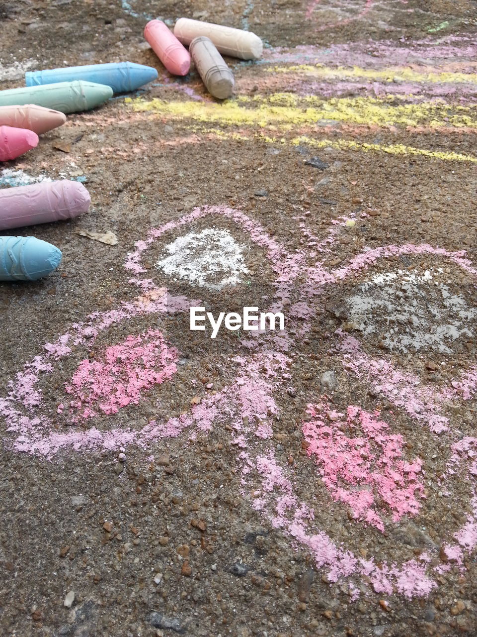 High angle view of butterfly drawing with chalks on field