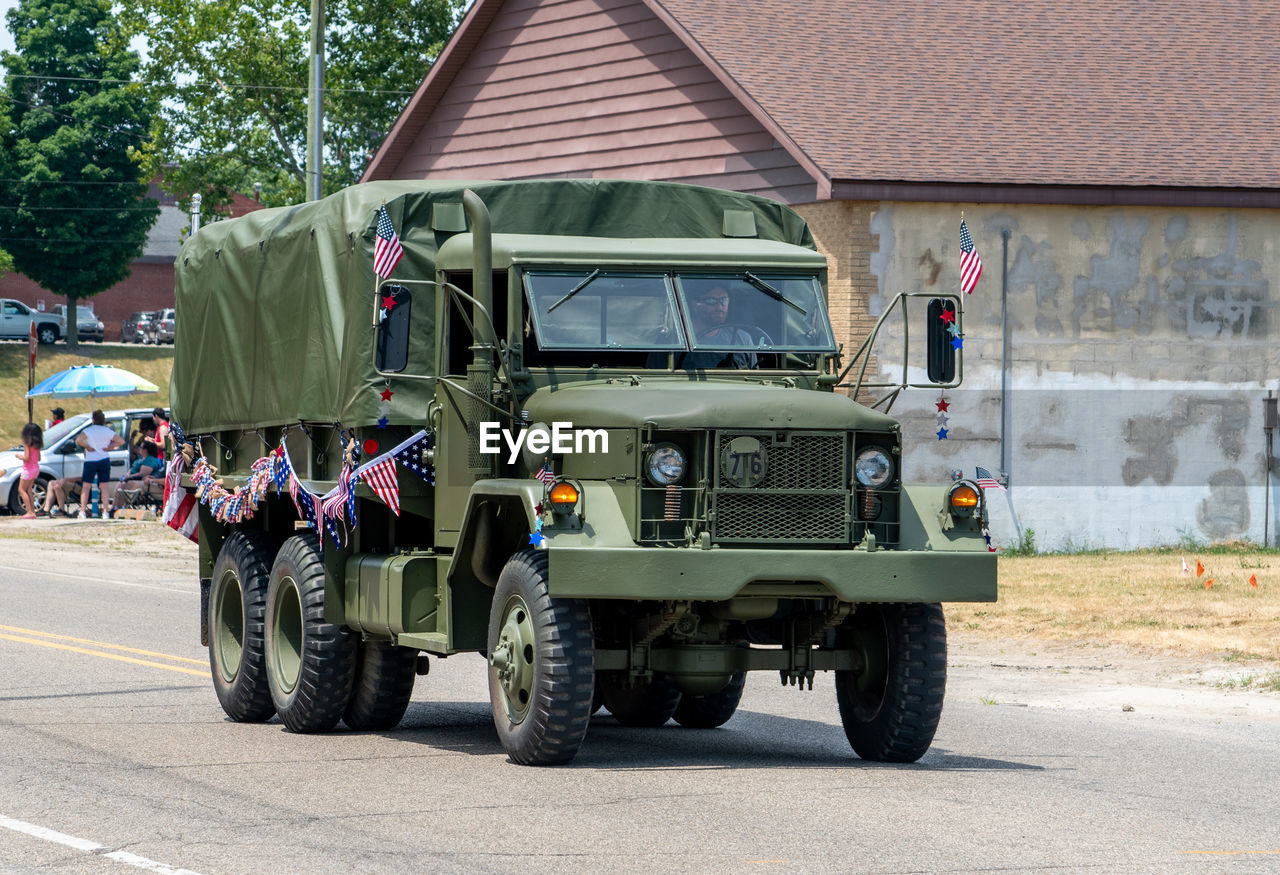 Eau claire mi usa july 4 2022 old army truck decorated with flags drives in a parade