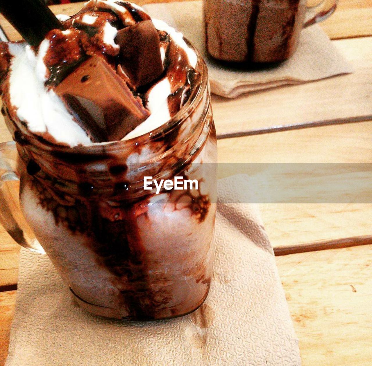 CLOSE-UP OF ICE CREAM WITH SPOON ON TABLE