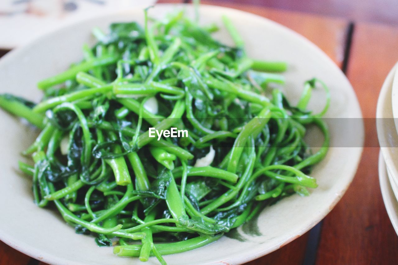 Garlic spinach in plate on table