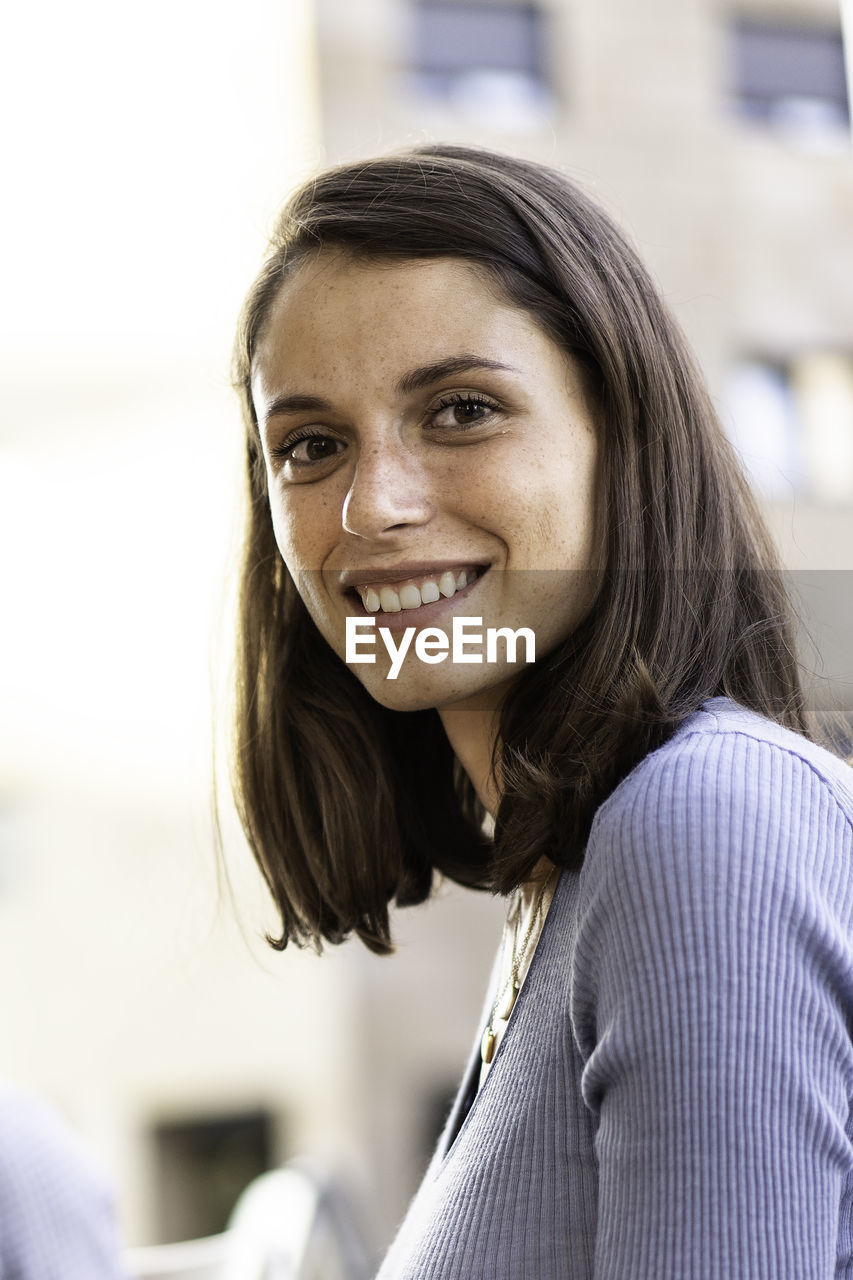 Portrait of smiling young woman outdoors