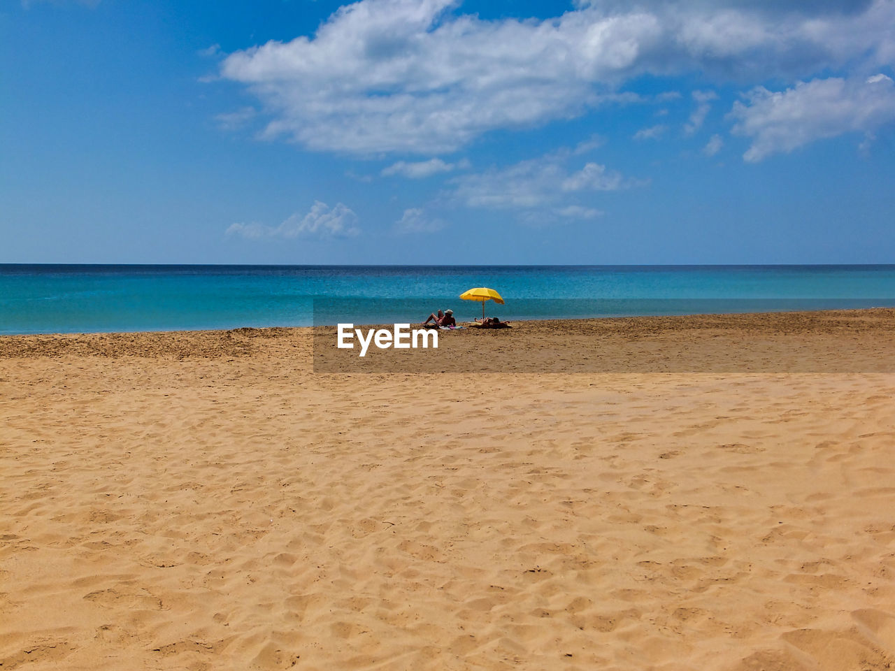 MEN ON BEACH AGAINST SKY