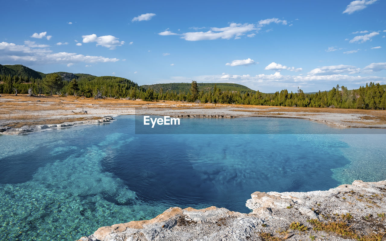 Scenic view of sapphire pool with sky in background at yellowstone national park
