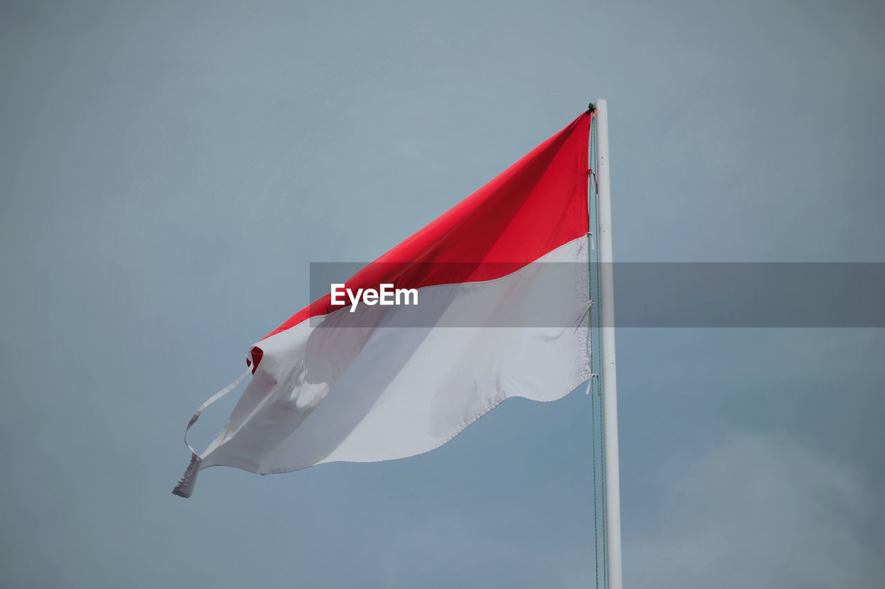 Low angle view of flag against sky