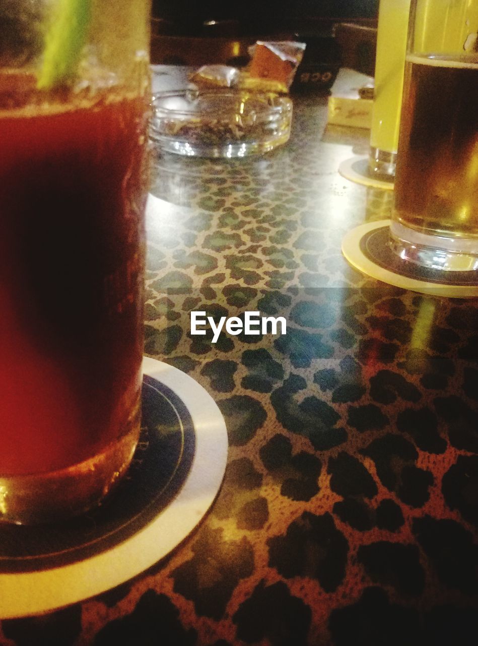 CLOSE-UP OF BEER GLASS ON TABLE AT RESTAURANT