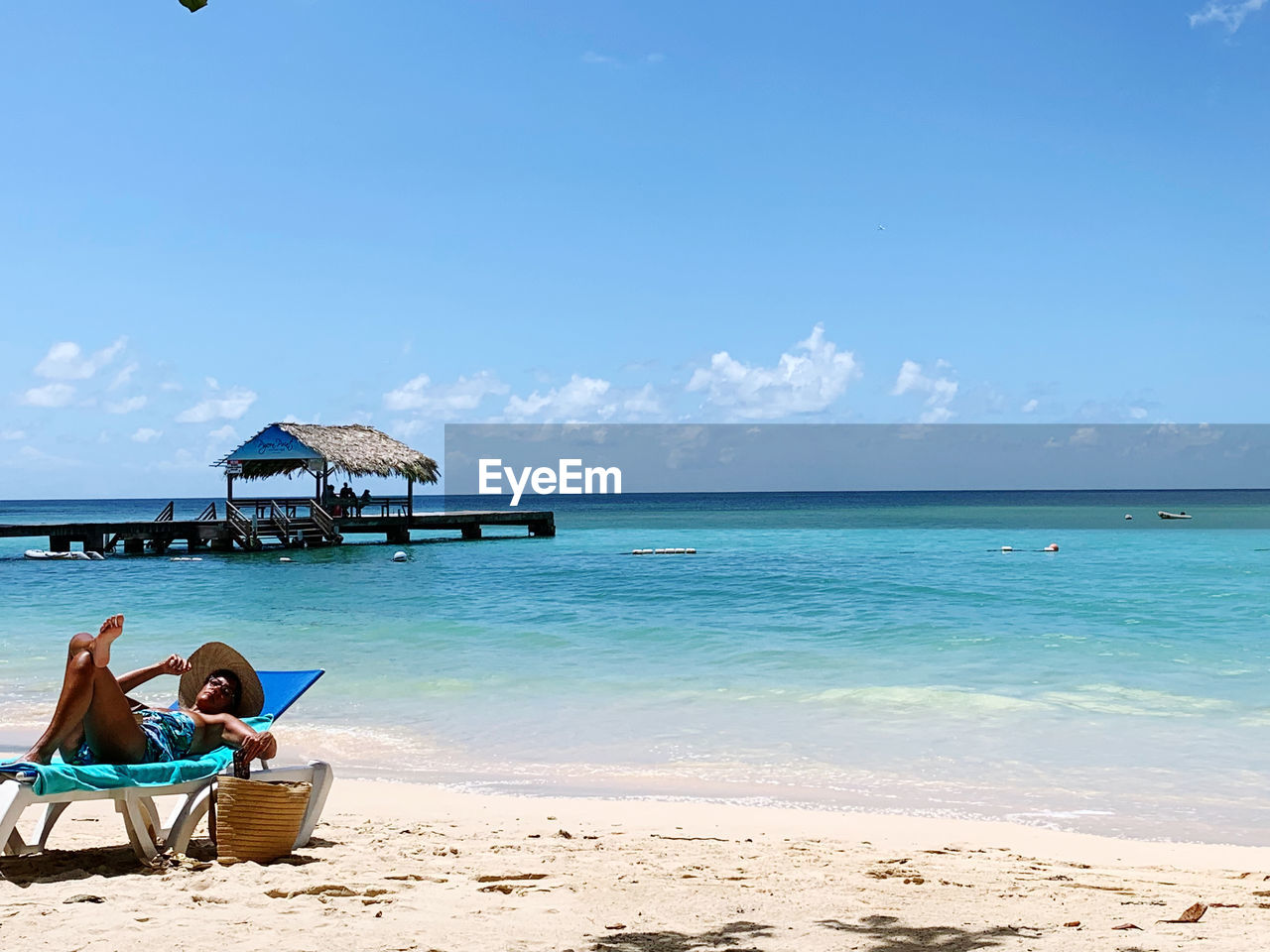 Scenic view of beach against blue sky