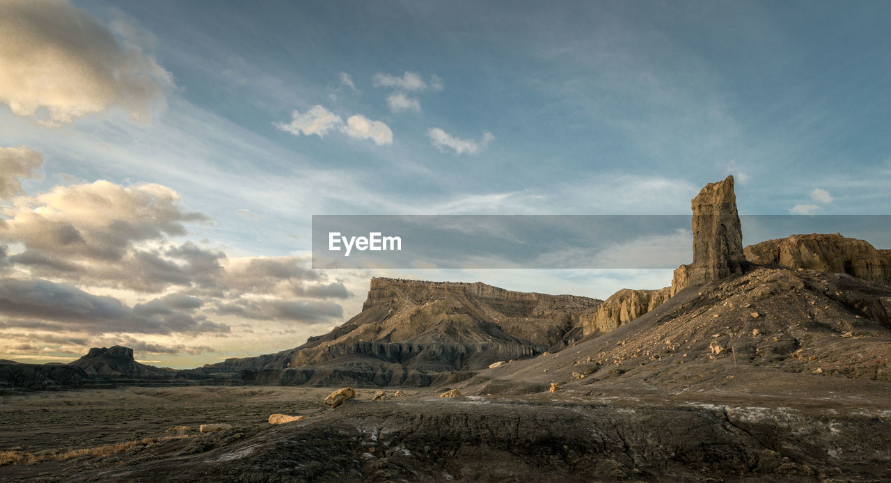 Scenic view of landscape against cloudy sky