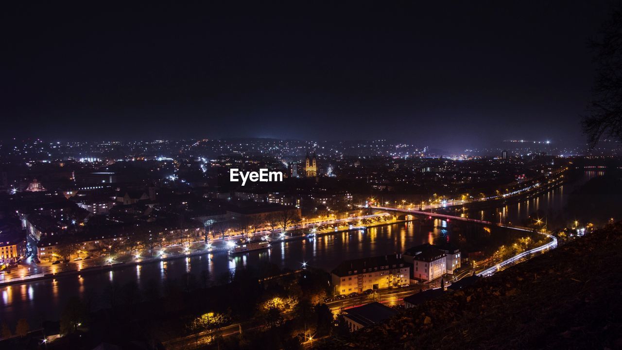 ILLUMINATED CITY AT WATERFRONT