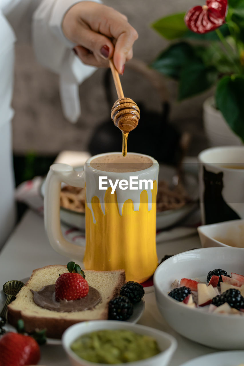 Cropped hand of woman having breakfast